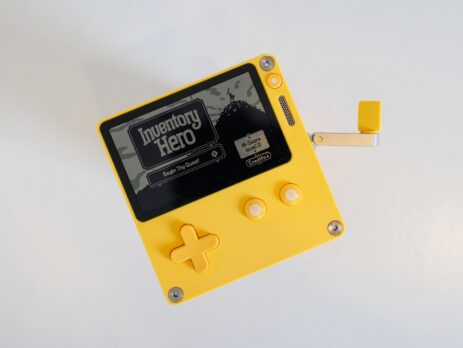a yellow and black gameboy with a white background